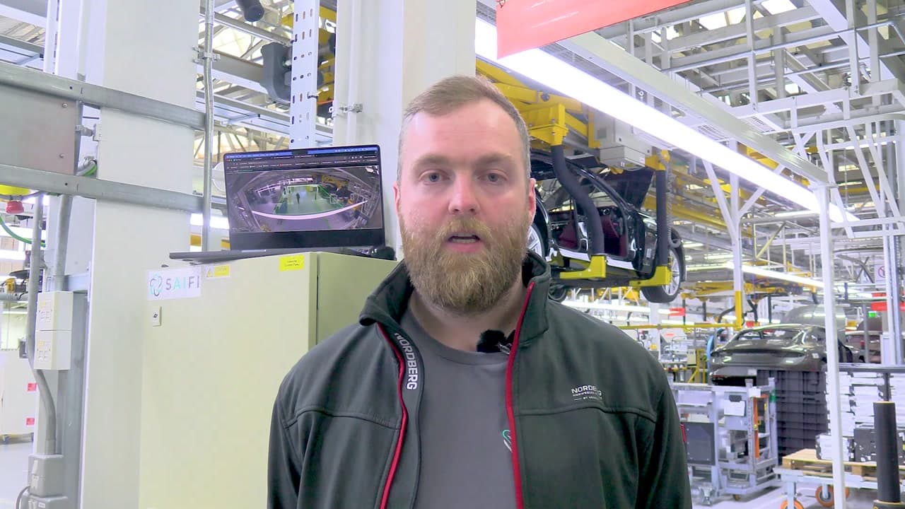 Tom Davies on the deployment site at a luxury automotive manufacturing facility in Crewe, with the SAiFI Edge Essential system visible on a laptop